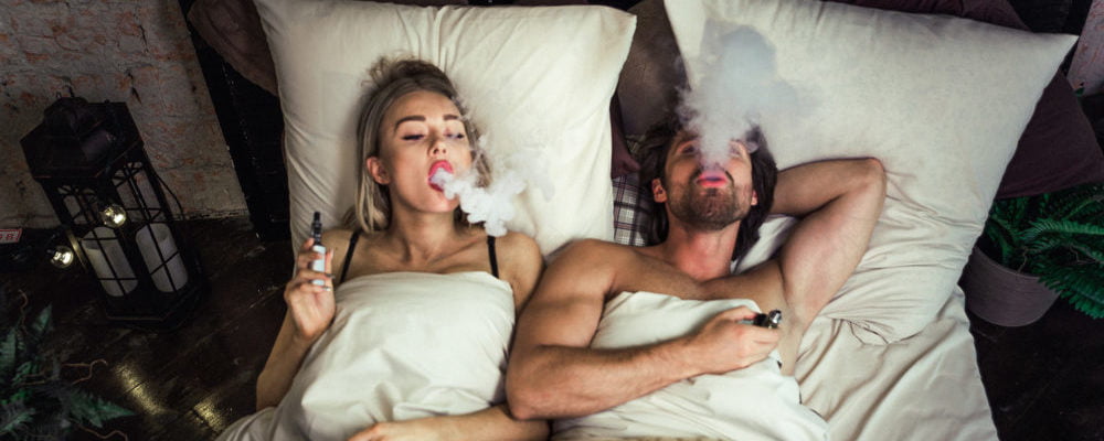 Caouple in bed vaping